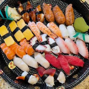 Lawrence Fish Market signature dishes Assorted Sashimi Platters, various Maki Rolls (e.g., Spicy Tuna, California), Nigiri, Party Trays.