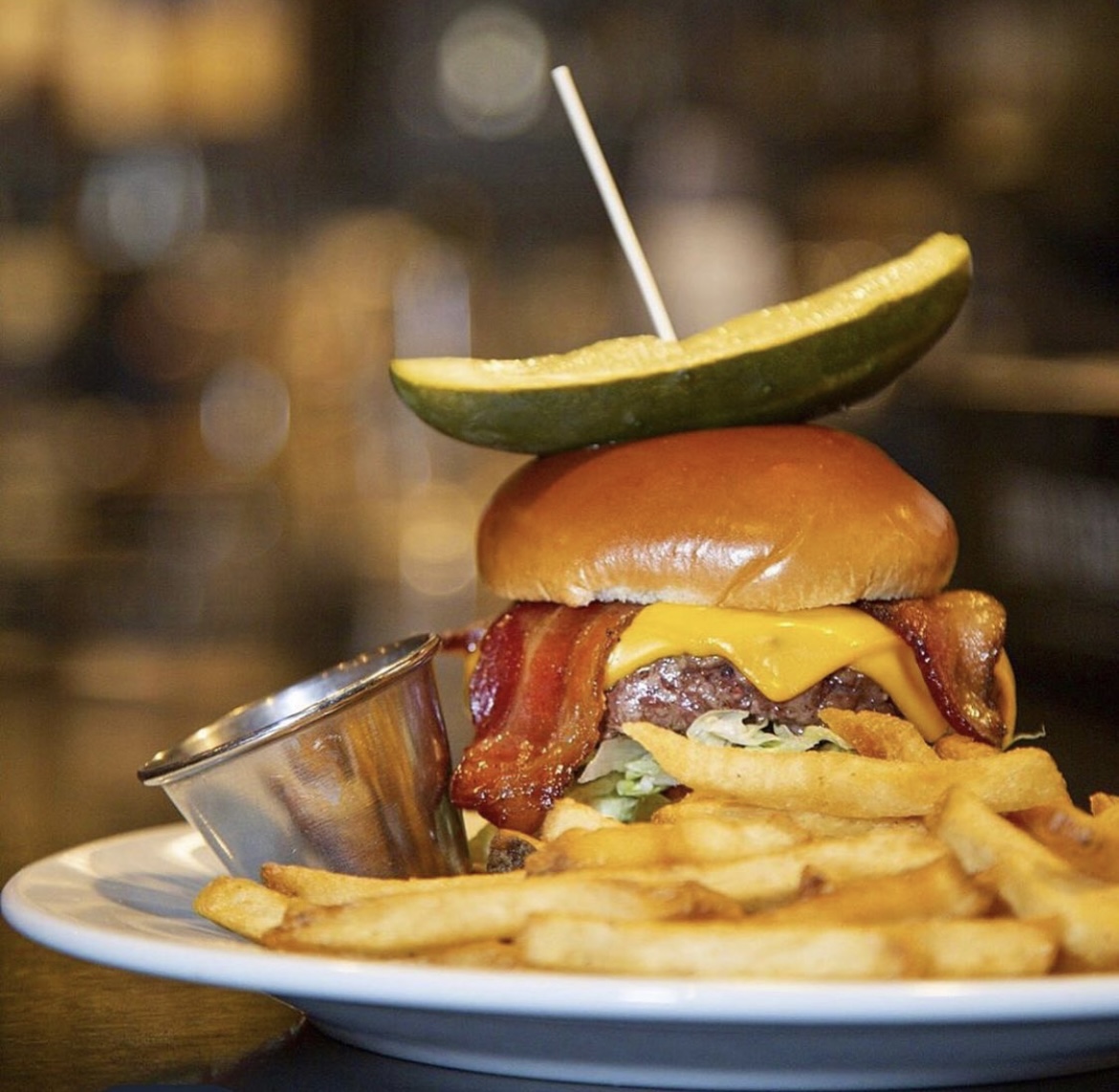 Local signature dishes Buffalo Tartare, Dry-Aged Steaks, Elk Rack, Local Burger