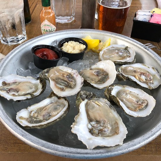 Fish Tale Grill by Merrick Seafood signature dishes Jumbo Lump Crab Cakes, Oyster Rockefeller, Fresh New England Steamers.