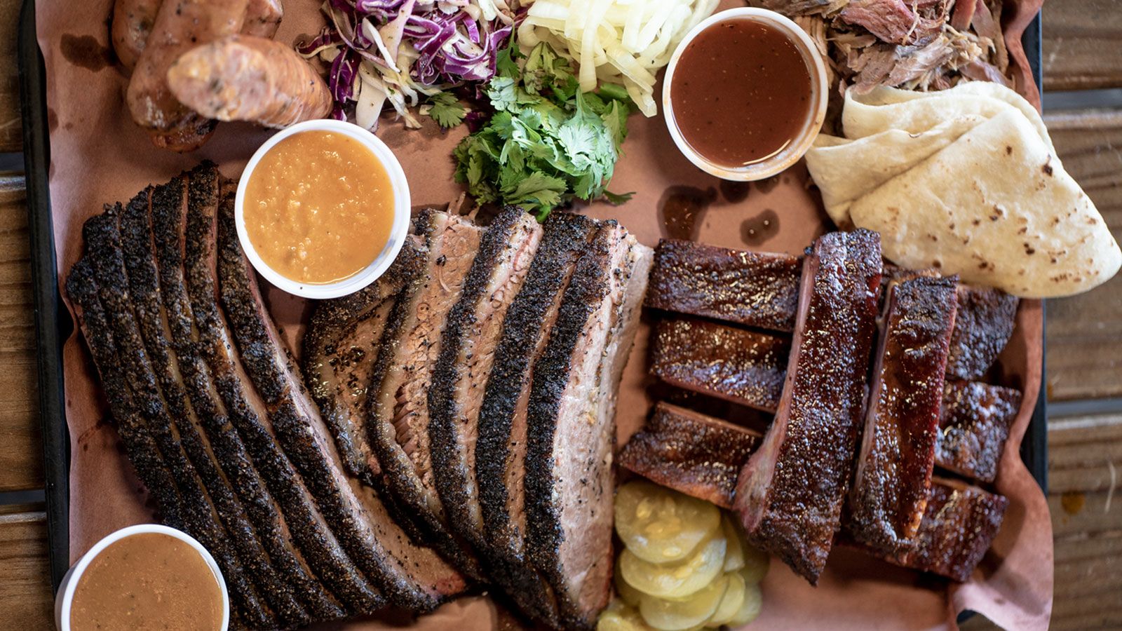 Valentina's Tex Mex BBQ signature dishes The Real Deal Holyfield (breakfast taco), Smoked Brisket Tacos, Smoked Carnitas.