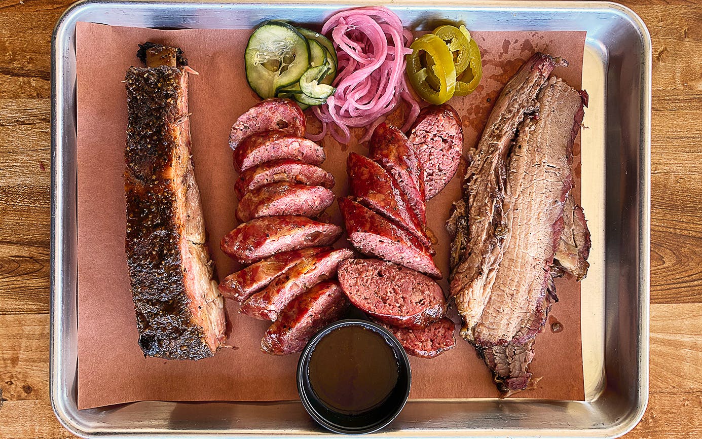 LaVaca BBQ signature dishes Big Red Ribs, Brisket Beans, Prime Brisket.