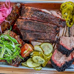 Moo's Craft Barbecue signature dishes Brisket, Chopped Brisket, Pork Ribs, Pulled Pork.
