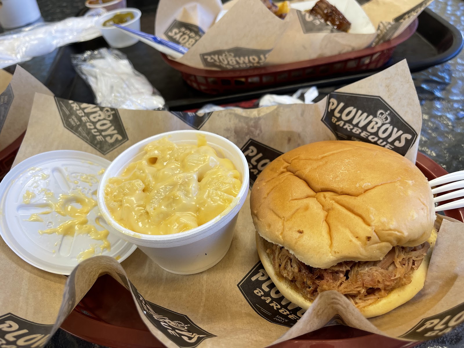 Plowboys Barbecue signature dishes Brisket or Burnt End Sandwich, Baby Back Ribs, St. Louis Style Ribs.
