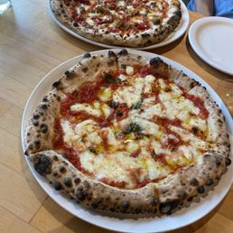 Cane Rosso signature dishes Margherita Pizza, The Honey Bastard Pizza, various creative specialty pizzas, handmade pastas.