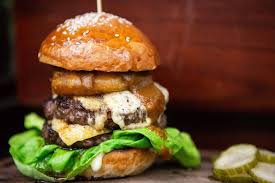 P.S. Steak signature dishes  Various cuts of steak (e.g., Ribeye, Filet Mignon, New York Strip), P.S. Burger, Lobster Mac & Cheese, Oysters, seasonal vegetable sides, Steak Tartare.