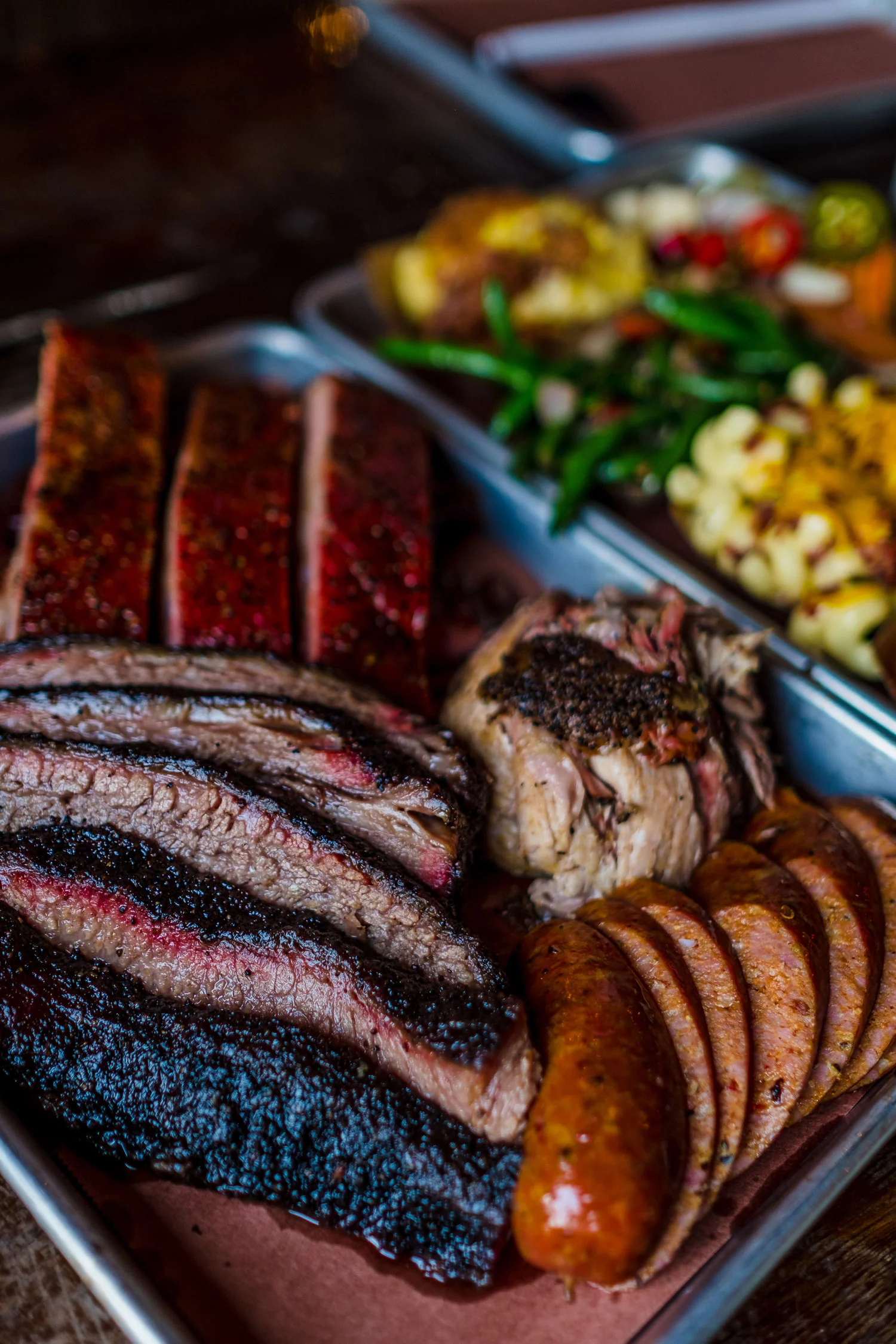 Truth BBQ signature dishes Brisket, Pork Ribs, Tater Tot Casserole, and a variety of layer cakes.
